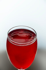 a piece of red liquid glass on a white background.
