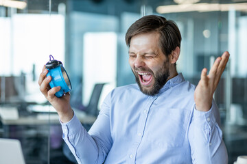 Excited man celebrating success in modern office environment