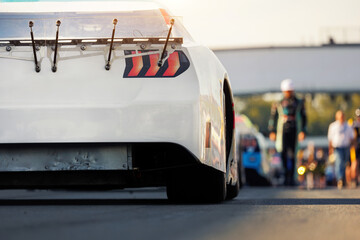 Back rear view Nascar Whelen euro series white racing sportscar car auto pit lane ready for race....