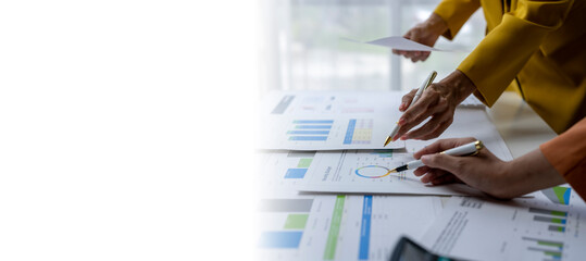 Businesswomen analyzing financial charts and graphs in the office