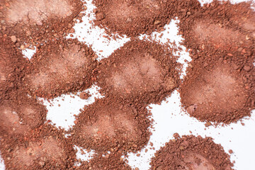 A mixture of different shades of eyeshadow on a white background.