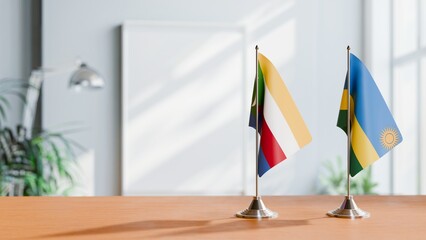 FLAGS OF COMOROS AND RWANDA ON TABLE