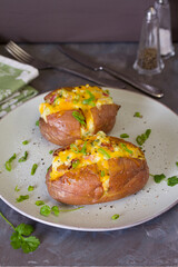 Cheesy stuffed baked potatoes topped with cheese, bacon and cream.