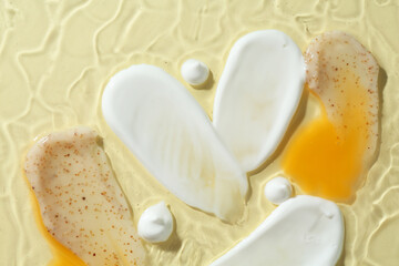 Samples of different cosmetic products on beige background, top view
