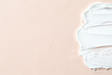 Smear of cosmetic product on beige background, top view. Space for text