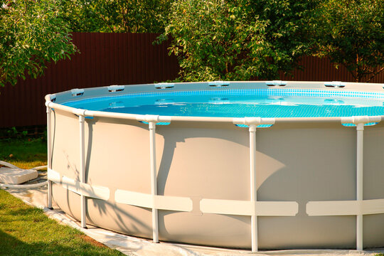 Above ground swimming pool outdoors on sunny day