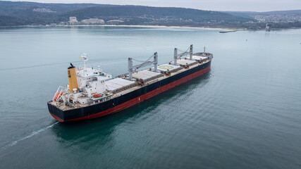 Aerial view of dry cargo ship. Bulk carrier cargo vessel. Ship logistic and transportation business...