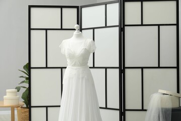 Beautiful wedding dress on mannequin in boutique