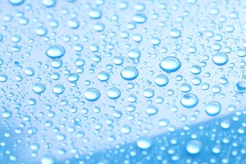 Water drops on light blue background, closeup