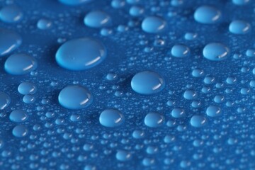 Water drops on blue background, above view