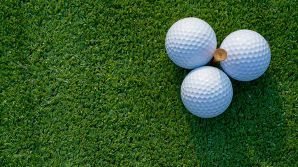 Golf ball is on a green lawn in a beautiful golf course with morning sunshine.