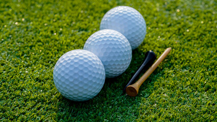 Golf ball is on a green lawn in a beautiful golf course with morning sunshine.