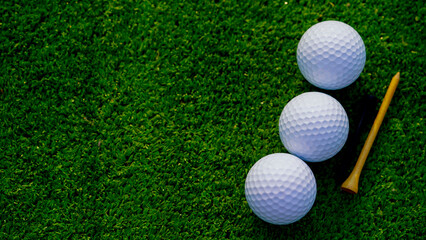 Golf ball is on a green lawn in a beautiful golf course with morning sunshine.