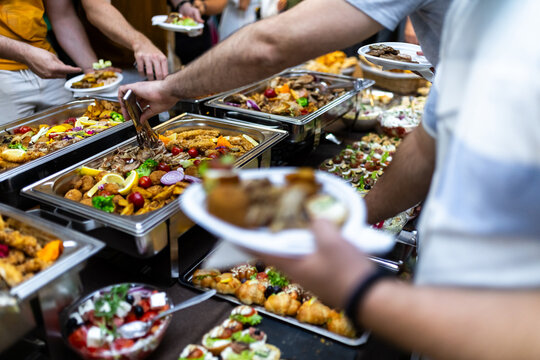 Catering spread featuring assorted dishes at a festive gathering in an indoor setting during a social event