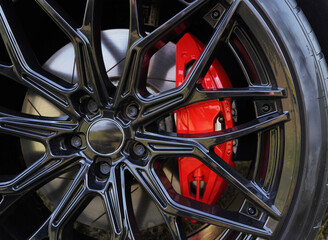 Alloy wheel with calipers and racing brakes of the sport car. Racing brake disc and low profile...