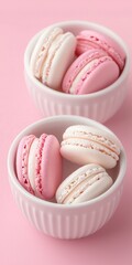 Obraz premium Delicious pink macarons in white bowls on a pink background.