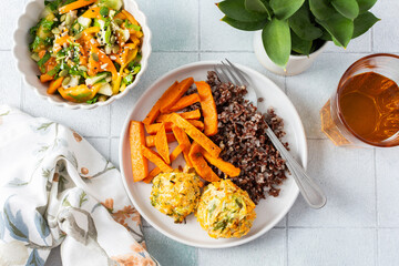 A delicious and wholesome plate featuring brown rice, sweet potatoes, and chickpea pancakes made...