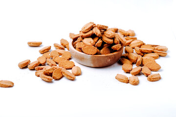 biscuits with coffee flavor, isolated on white background, on a wooden bowl