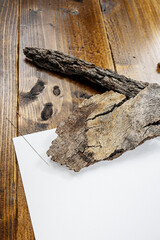 white sheet on wooden background with bark