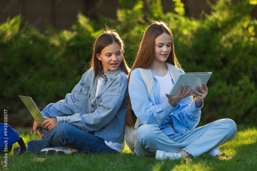 Canvas Prints young school girl laptop sit near the school and study