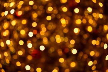 Bokeh effect of the Christmas tree. Festive decoration. Full of ornaments. Winter season, winter festive. Christmas celebration, Xmas celebration. For background use.