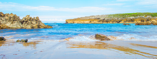 Obraz premium Wild shore with rocks and stones along the coast of northern Spain, Muxia, Galicia, September 12, 2024