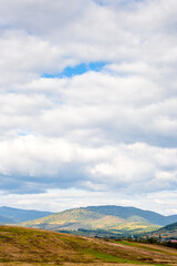 countryside of ukraine. cloudy afternoon. autumn landscape in mountains. grassy field and rolling hills. rural scenery