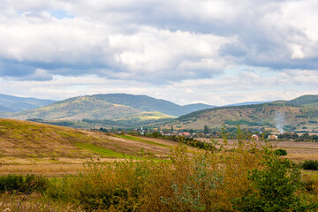 Obraz premium countryside of ukraine. cloudy afternoon. autumn landscape in mountains. grassy field and rolling hills. rural scenery