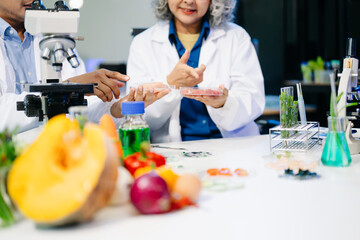 Food scientists in lab coats, testing samples, and analyzing food safety and quality in a modern laboratory