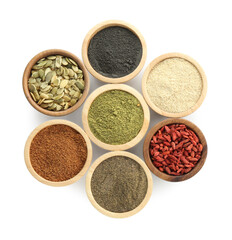 Different superfood powders, pumpkin seeds and goji berries in bowls isolated on white, top view