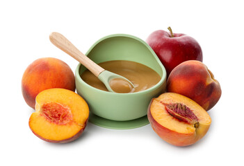 Delicious baby food with spoon in bowl and fresh ingredients isolated on white