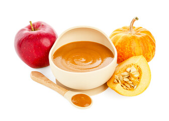 Delicious baby food in bowl with spoon and fresh ingredients isolated on white