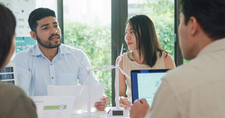Group diverse Asia businesspeople talk ESG strategies risk management workshop, SDGs report, global warming, green finance and investment and net zero waste lifestyles in boardroom training building.