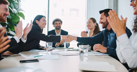 Ending of team meeting in business company. People in official clothing. Everyone shaking hands and...