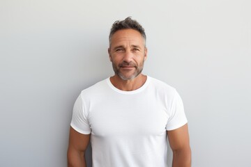 Obraz premium Portrait of a glad man in his 40s donning a trendy cropped top over minimalist or empty room background