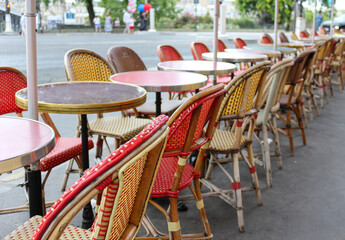 Charming outdoor Parisian cafe with empty tables and chairs, perfect for travel, leisure, and European lifestyle concepts.