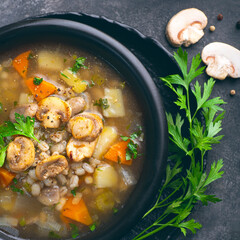 Mushrooms transparent  healthy soup with champignon, vegetables and pearl barley. Simple, full of vegan proteins cuisine for the cold season. Forest food. Baltic , Scandinavian cuisine, square crop