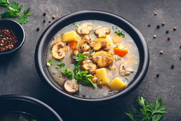 Mushrooms transparent  healthy soup with champignon, vegetables and pearl barley. Simple, full of vegan proteins cuisine for the cold season. Forest food. Baltic , Scandinavian cuisine,  front view