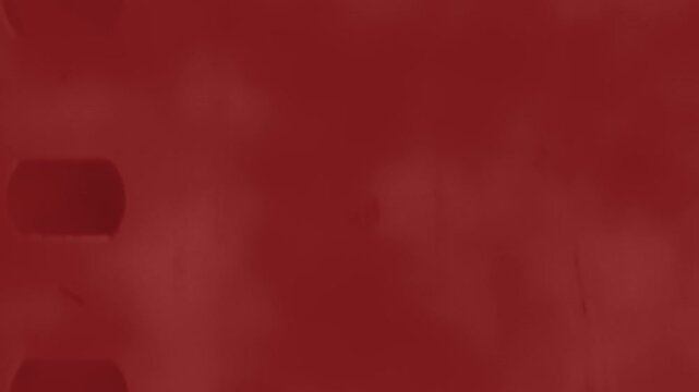 A red film strip with black borders evoking the essence of movies or films. A simple yet powerful visual representation of cinematic storytelling