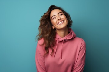 Obraz premium Portrait of a blissful woman in her 30s wearing a thermal fleece pullover isolated on solid color backdrop