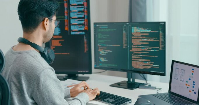 Young adult Asia male freelance eyeglasses typing write prompt AI bot IT app smart program nomad, video game, terminal with coding, user interface, designer, big data center on desktop computer.