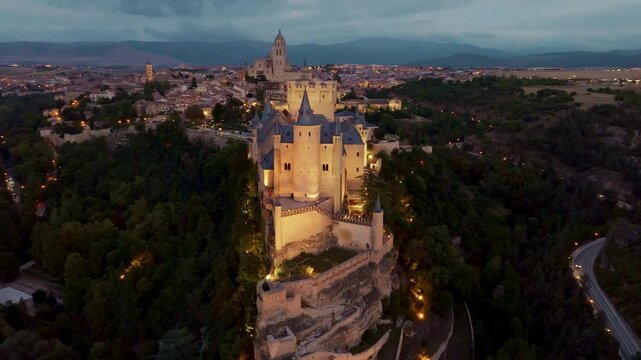night aerial view of Cathedral and Alcazar of Segovia, Spain. Drone view. Flying over Alcazar of Segovia medieval castle with night illumination