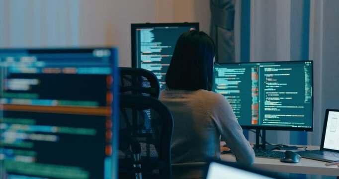 Young Asia female freelance eyeglasses typing write prompt AI bot IT app smart program nomad, video game, terminal with coding language, designer, big data center on desktop computer in night office.