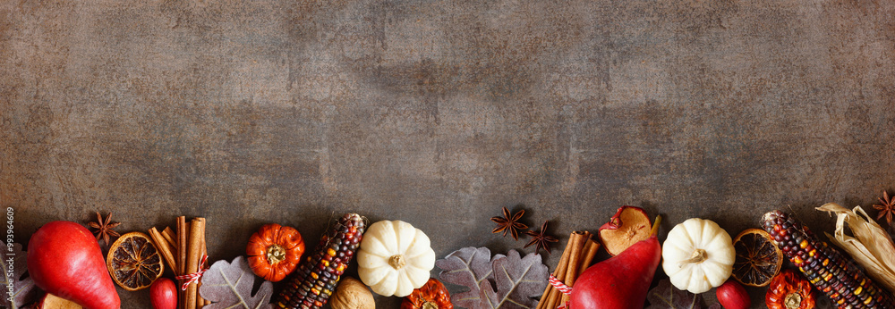 Poster autumn border of pumpkins, leaves and baking spices. bottom border on a dark stone banner background
