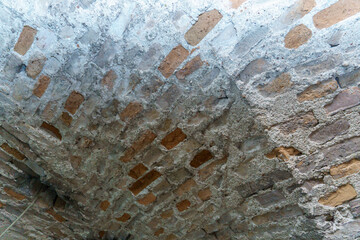 The vaulted ceilings in the old red brick building. An old dusty corridor in the dungeon. The study of antediluvian buildings and structures.