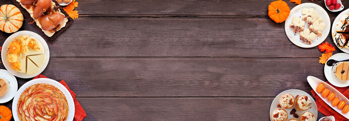 Autumn desserts double border. Table scene with a selection of gourmet fall sweet foods. Above view over a dark wood banner background. Copy space.