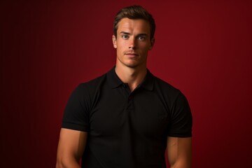 Obraz premium Portrait of a content man in his 20s wearing a sporty polo shirt isolated on solid color backdrop