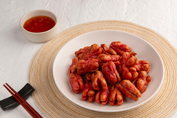 Air fryer thai red sausage,Crispy Chicken Cocktail Sausage in white plate.with sweet chilli dipping sauce.healthy cooking on junk food.