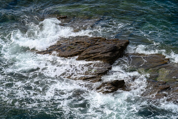 waves splashing and water spray over the rocks in the sea