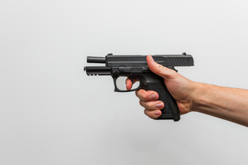 Close up of a person demonstrating holding a firearm / pistol with one hand shooting hands on the trigger